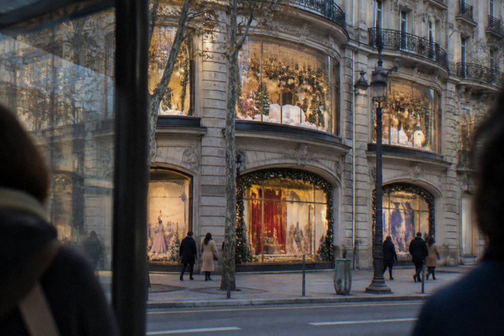 Ornate department store facade with decorated holiday window displays at night