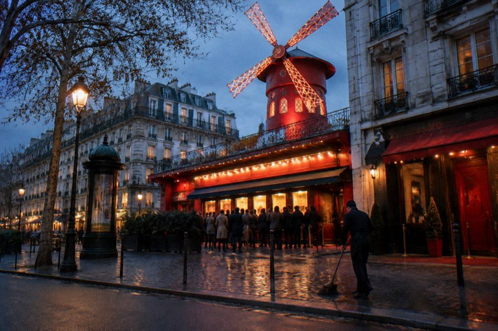 Theatre entrance with a lit marquee on a Paris street in the evening