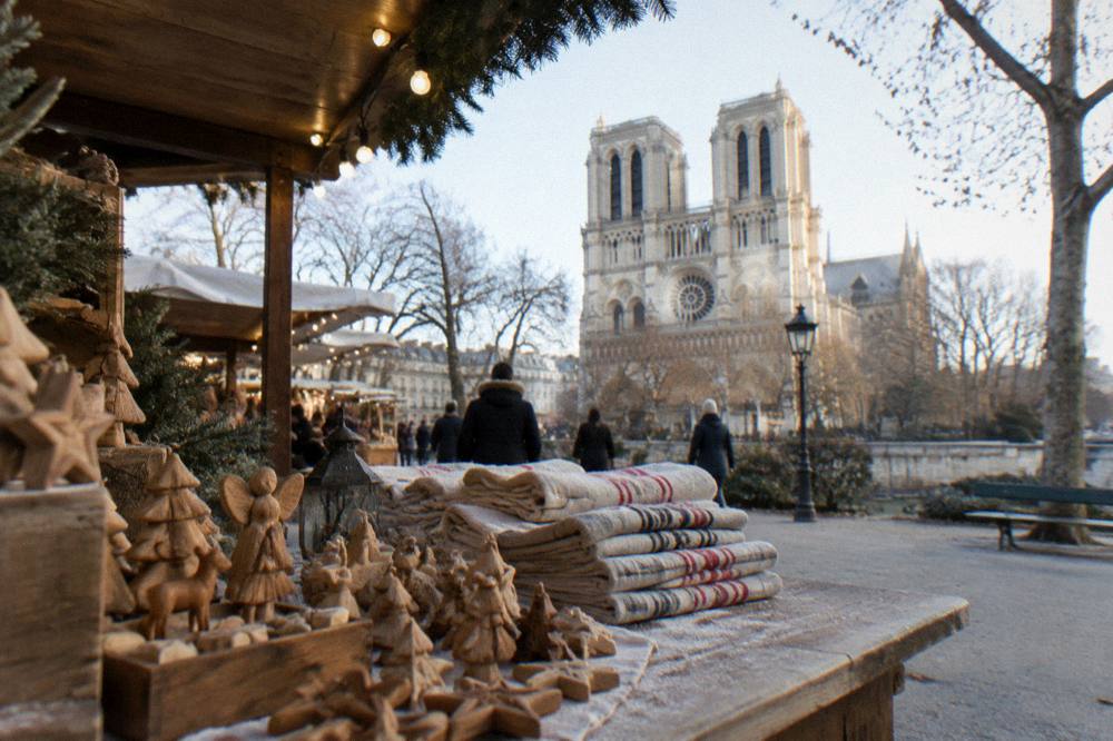 Artisan market stalls with handcrafted goods under warm string lights