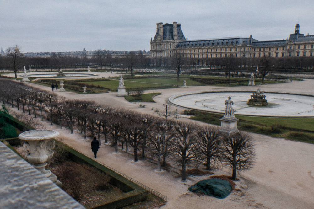 Palace courtyard in winter with leafless trees and overcast sky